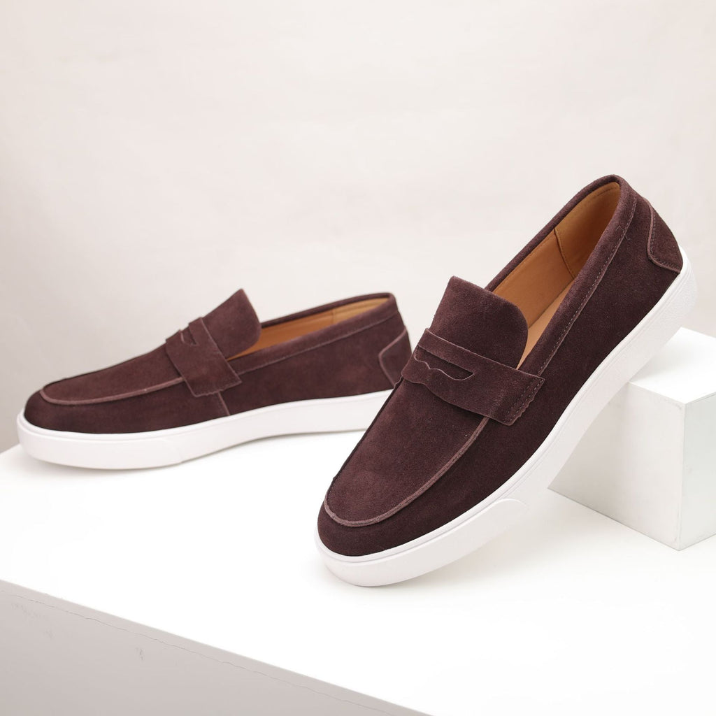 Men's penny loafers with moc toes, strap detail and white flat soles