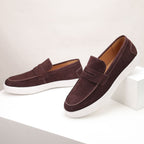 Men's penny loafers with moc toes, strap detail and white flat soles