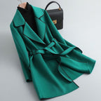 Women's long-sleeved belted trench coat with contrast piping and buttoned cuffs