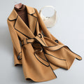 Women's long-sleeved belted trench coat with contrast piping and buttoned cuffs