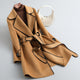 Women's long-sleeved belted trench coat with contrast piping and buttoned cuffs
