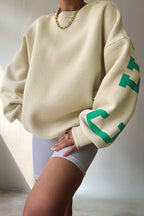 Women's crew-neck sweatshirt with contrasting letter graphics on the sleeves