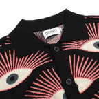 Men's black knitted polo shirt with repeated pink, cream and grey eye pattern