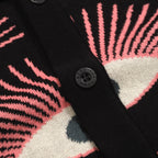 Men's black knitted polo shirt with repeated pink, cream and grey eye pattern