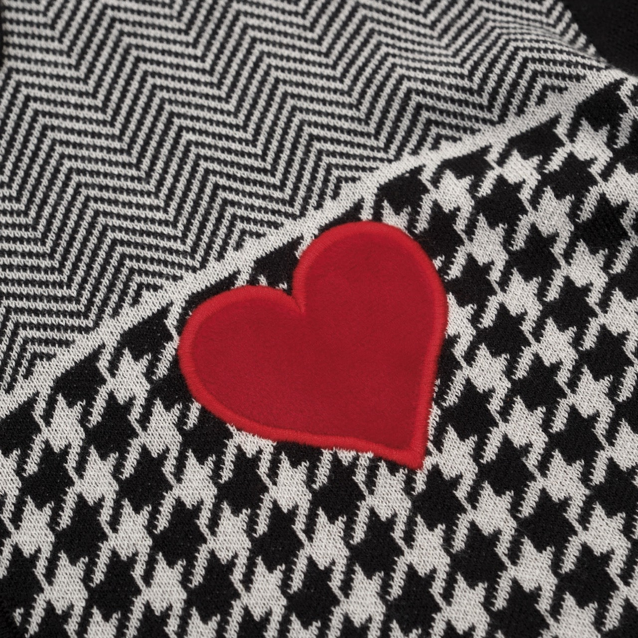 Men's black knitted polo cardigan with houndstooth pattern and red heart patch