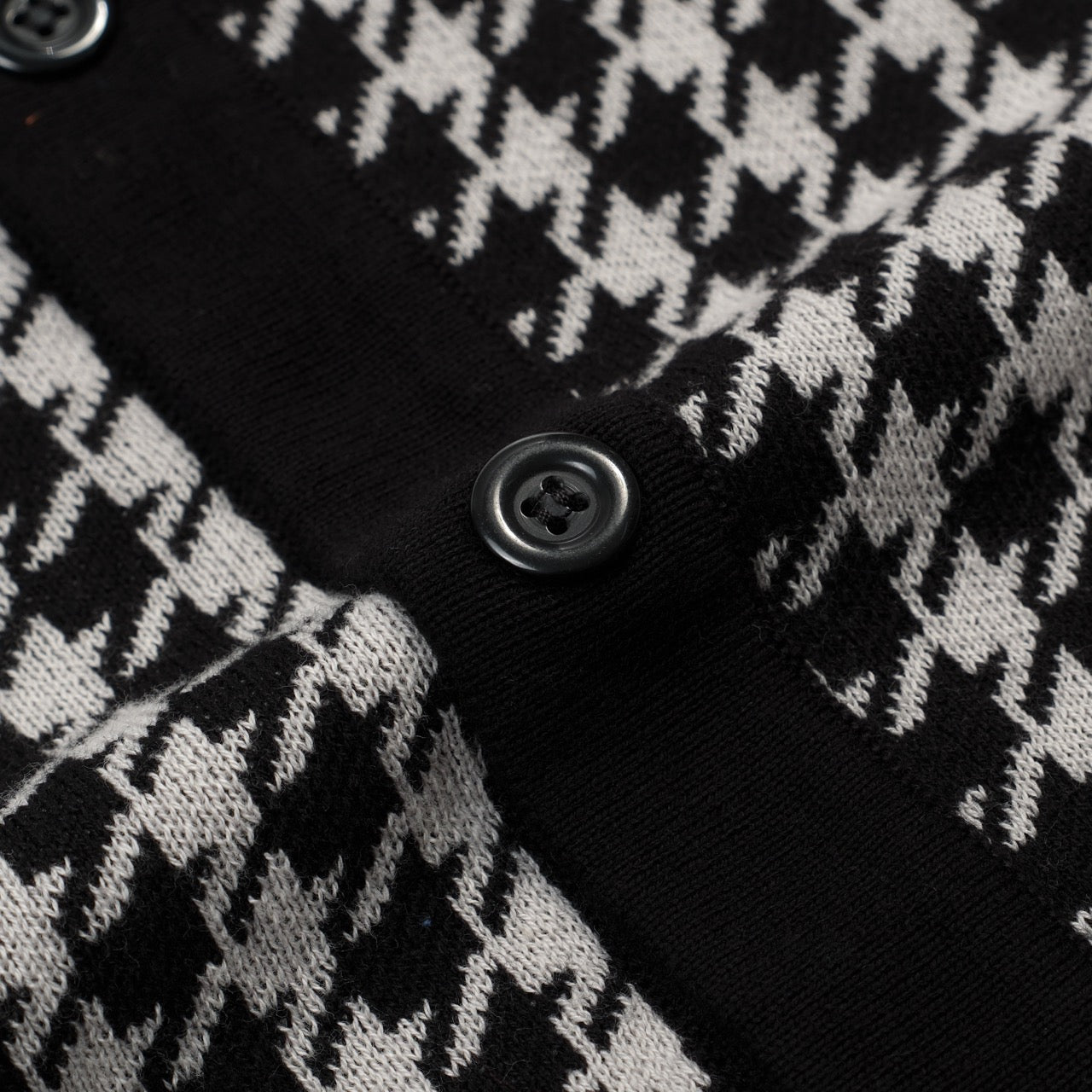 Men's black knitted polo cardigan with houndstooth pattern and red heart patch