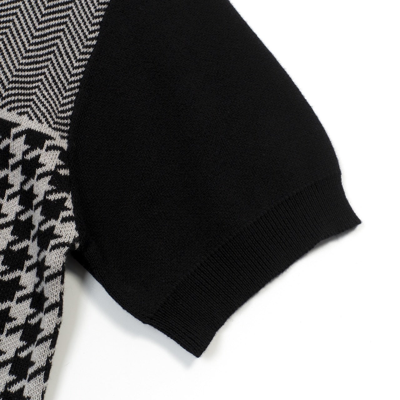 Men's black knitted polo cardigan with houndstooth pattern and red heart patch