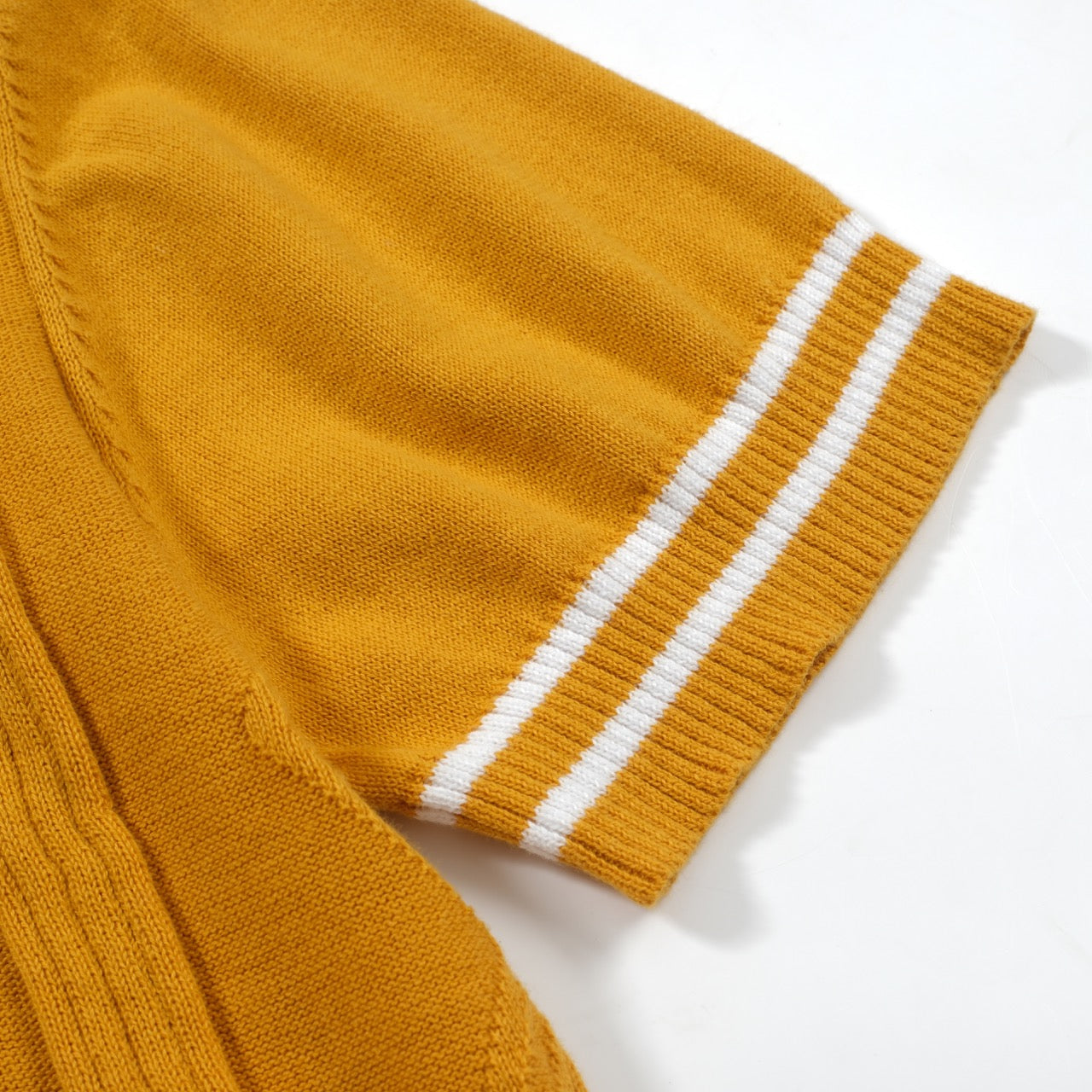Yellow textured knit polo shirt with striped collar and short sleeves