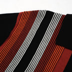 Men's black knit polo with red, orange and white vertical stripes