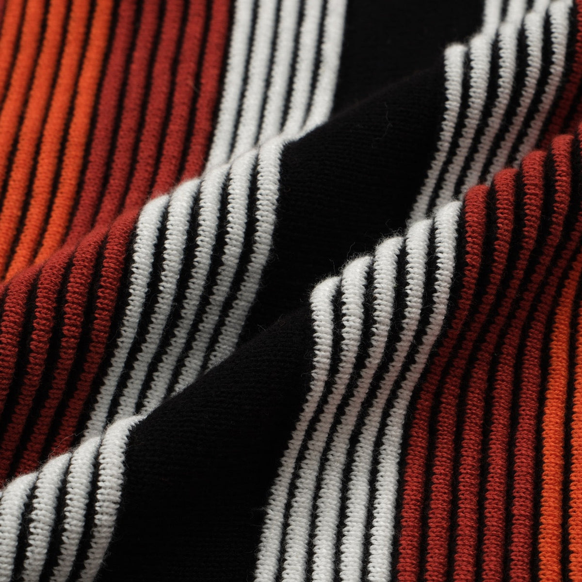 Men's black knit polo with red, orange and white vertical stripes