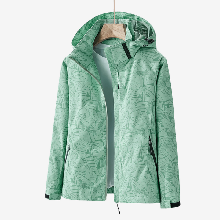 Women's hooded leaf print windbreaker jacket with long sleeves and zipped pockets