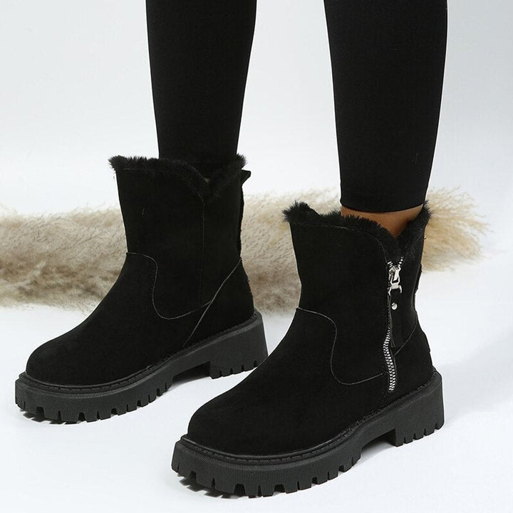 Women's ankle boots with faux fur trim, side zips and chunky lug soles