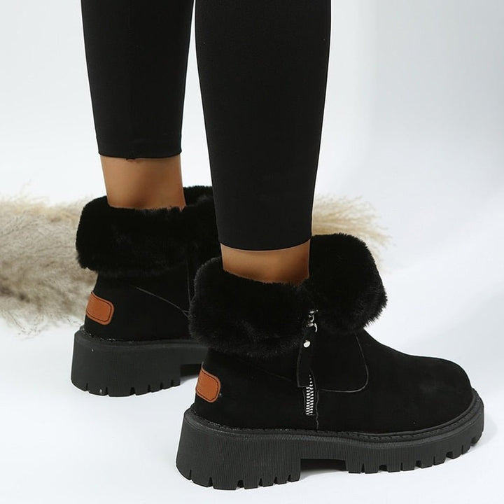Women's ankle boots with faux fur trim, side zips and chunky lug soles