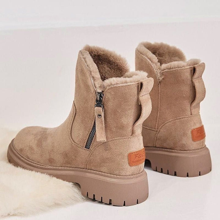 Women's ankle boots with faux fur trim, side zips and chunky lug soles