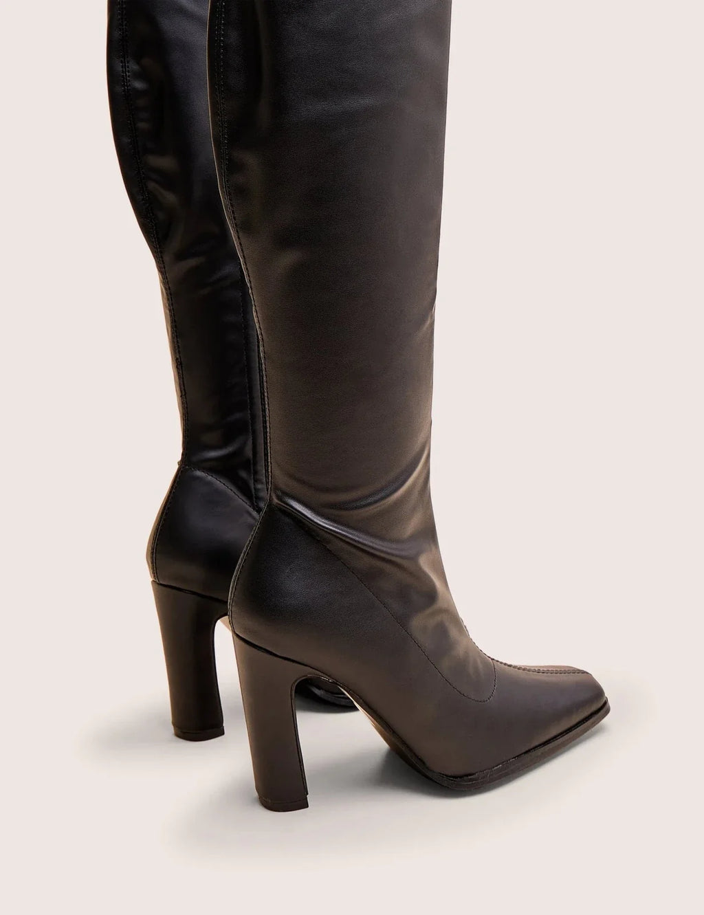 Women's black knee-high boots with pointed toes and block heels