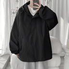 Women's oversized hooded windbreaker jacket with snap front and zip pockets