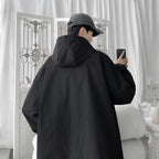 Women's oversized hooded windbreaker jacket with snap front and zip pockets