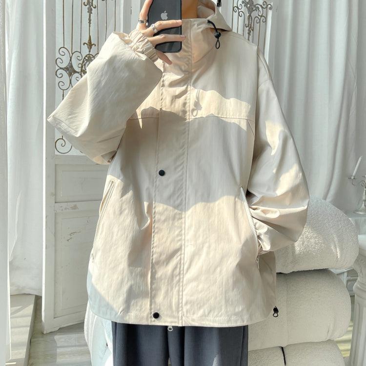 Women's oversized hooded windbreaker jacket with snap front and zip pockets