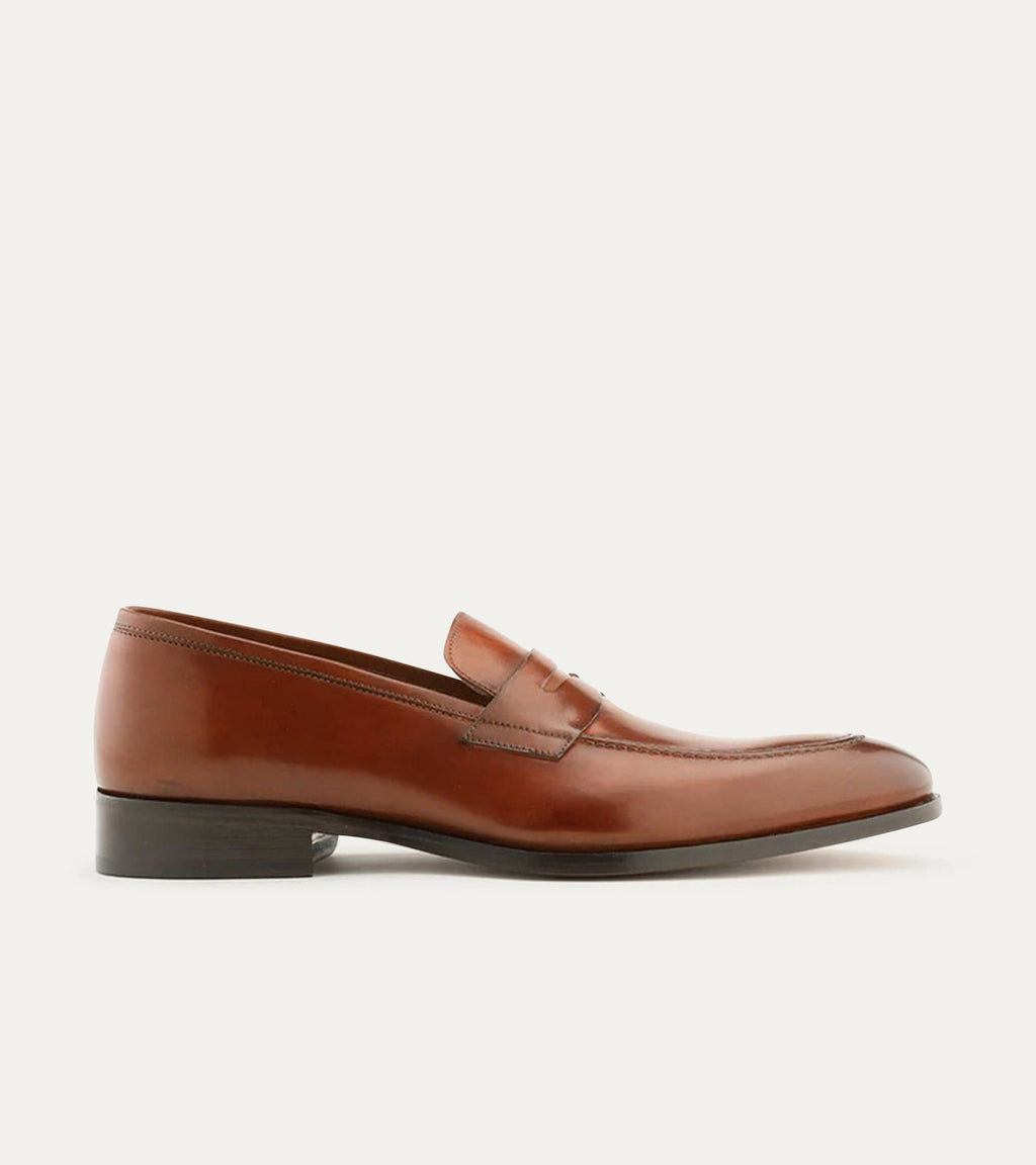 Men's brown polished penny loafer with almond toe and low heel