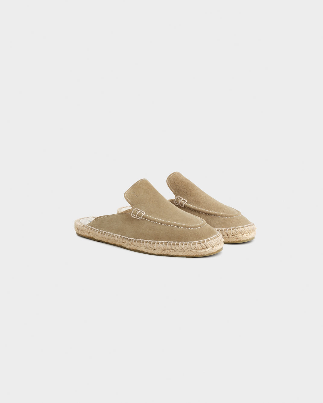 Beige unisex loafer mules with rounded toes, open heels and flat woven-effect soles