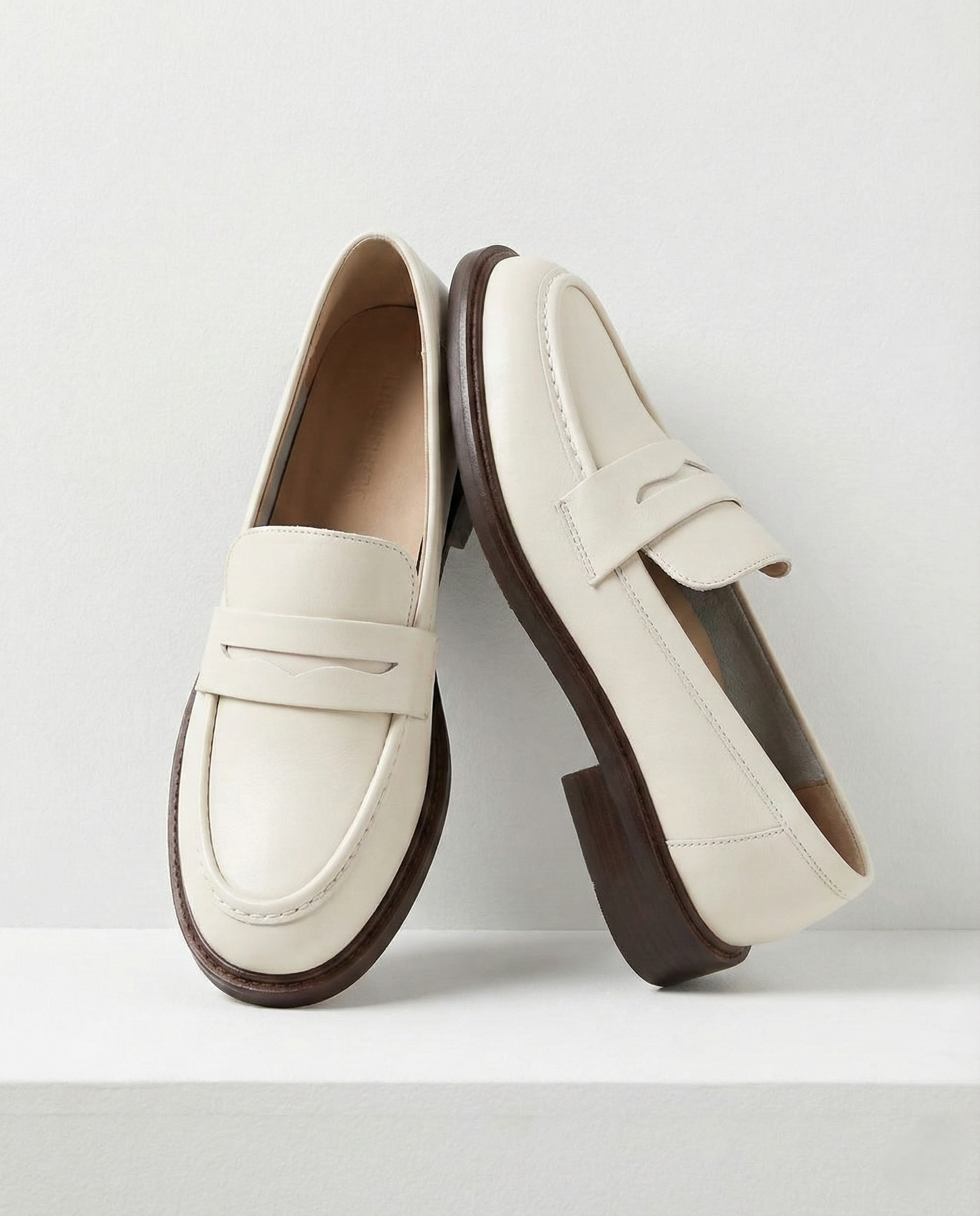 Women's penny loafers with apron stitching and low heel