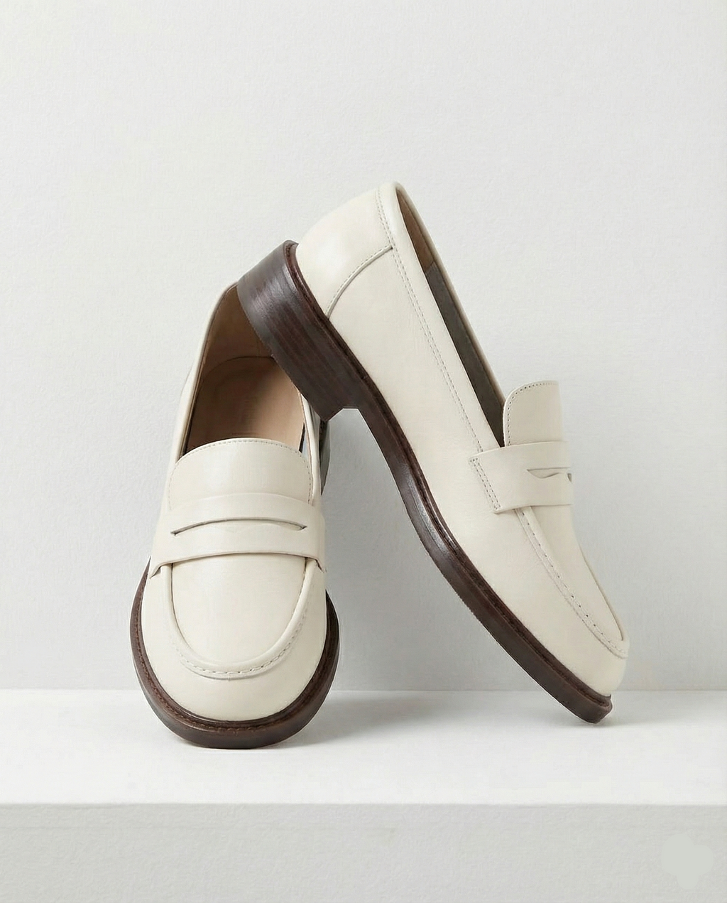 Women's penny loafers with apron stitching and low heel