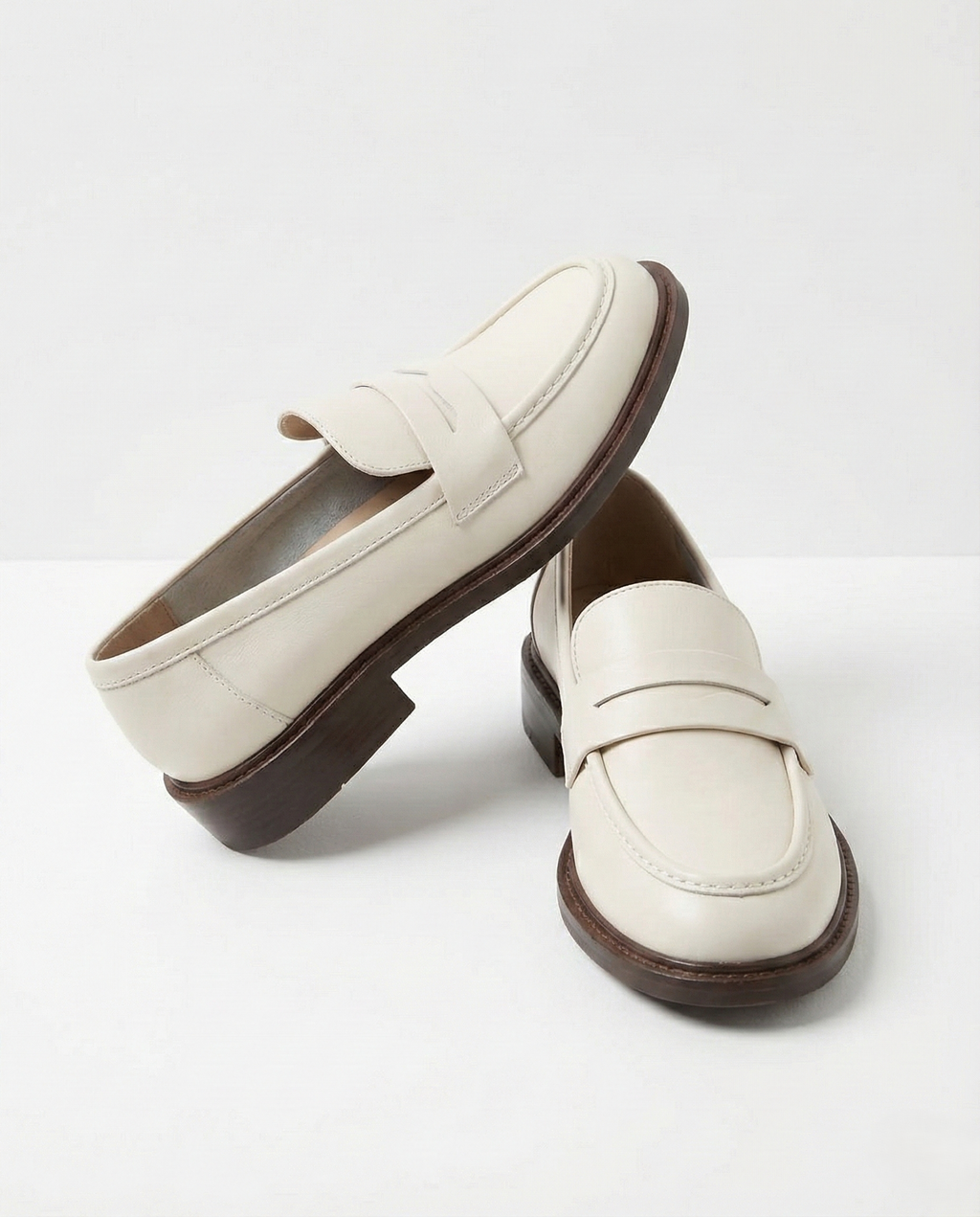 Women's penny loafers with apron stitching and low heel