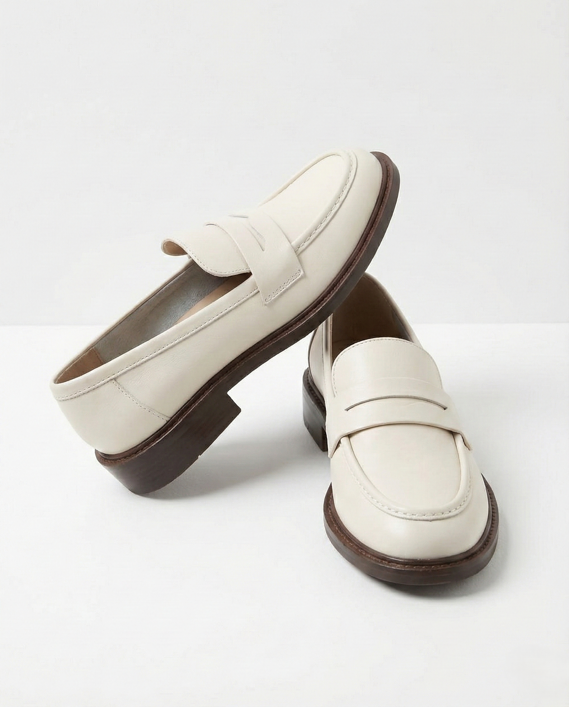Women's penny loafers with apron stitching and low heel