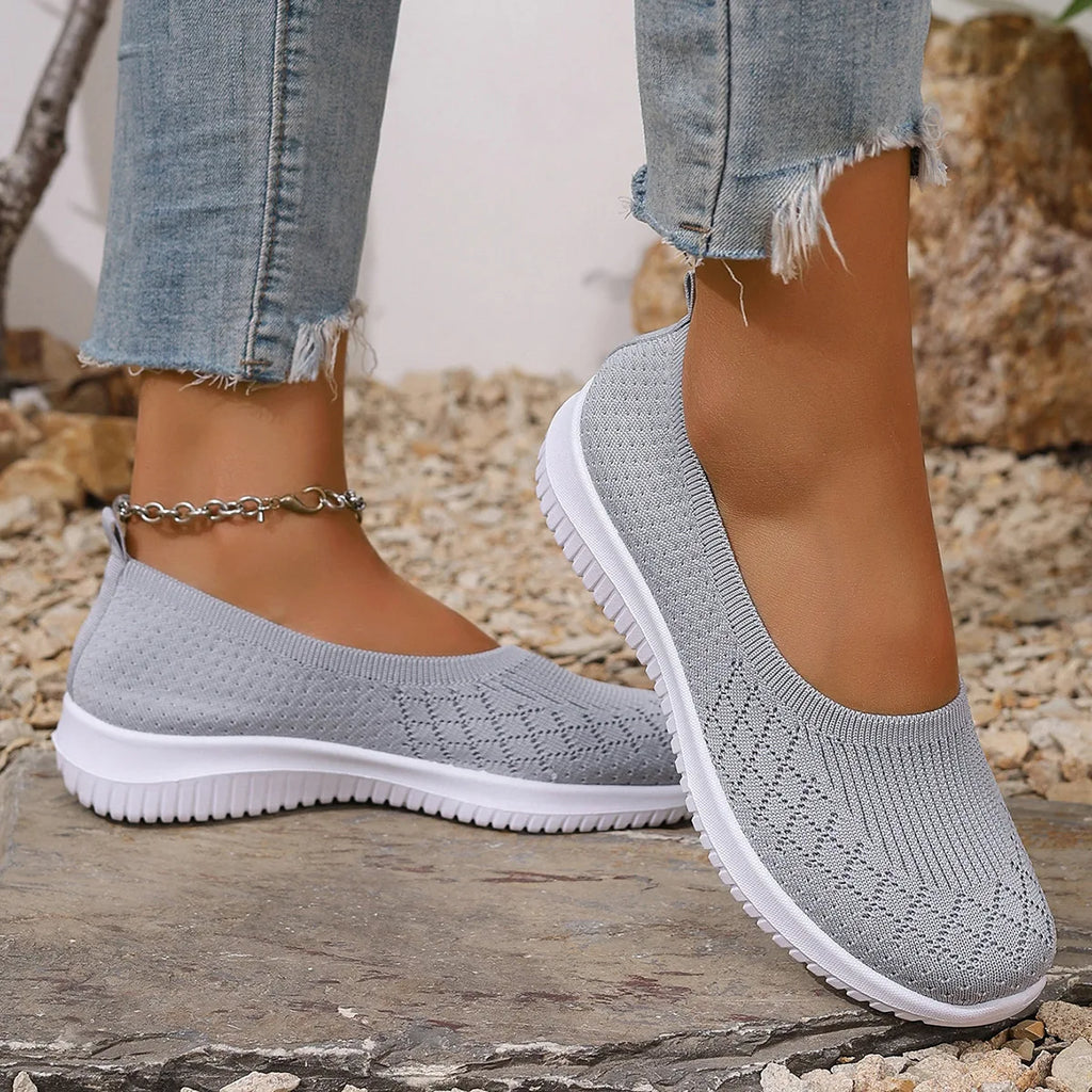 Women's knitted slip-on shoes with closed rounded toe and white ridged sole