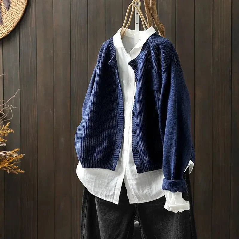 Women's textured knit cardigan with buttons over a white shirt