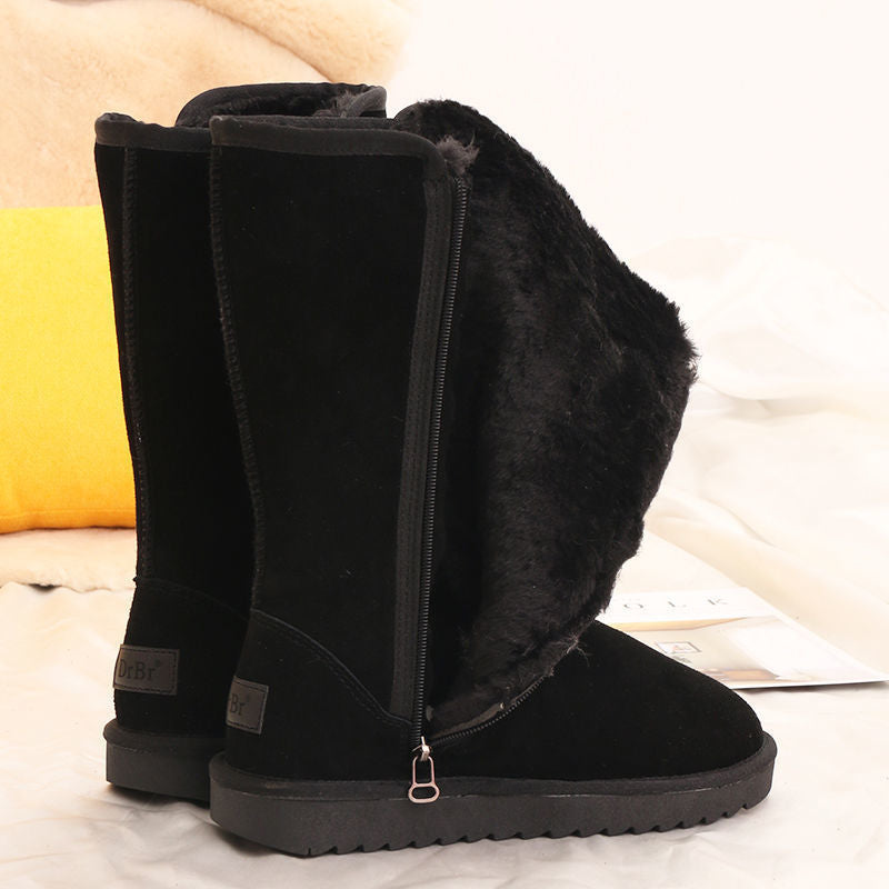 Black tall winter boots with furry trim, side zips and flat ridged soles