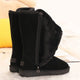 Black tall winter boots with furry trim, side zips and flat ridged soles