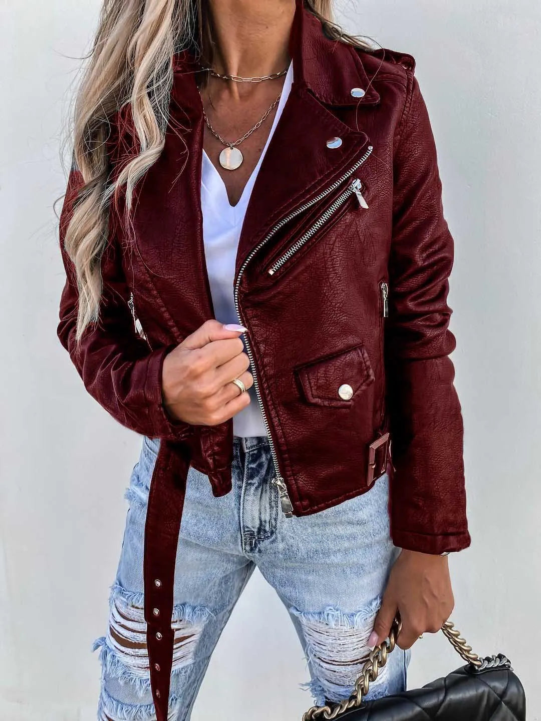 Women's cropped biker jacket with lapels, zips, studs and belted waist