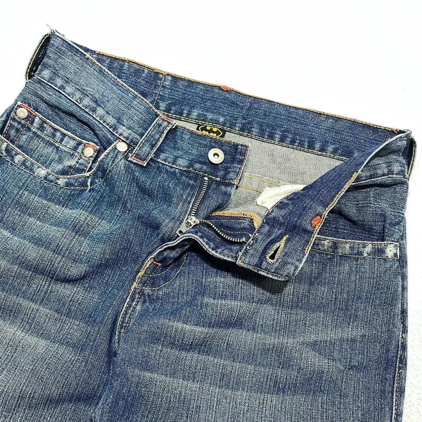 Blue Batman graphic jeans with wide legs and rear pocket patches