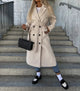 Women's long belted trench coat with notched lapels and double-breasted buttons