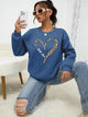 Women's crew-neck sweatshirt with leopard heart graphic and long sleeves