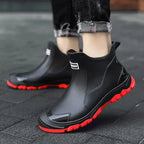 Black unisex ankle terrain boots with elastic side panels and chunky lug soles