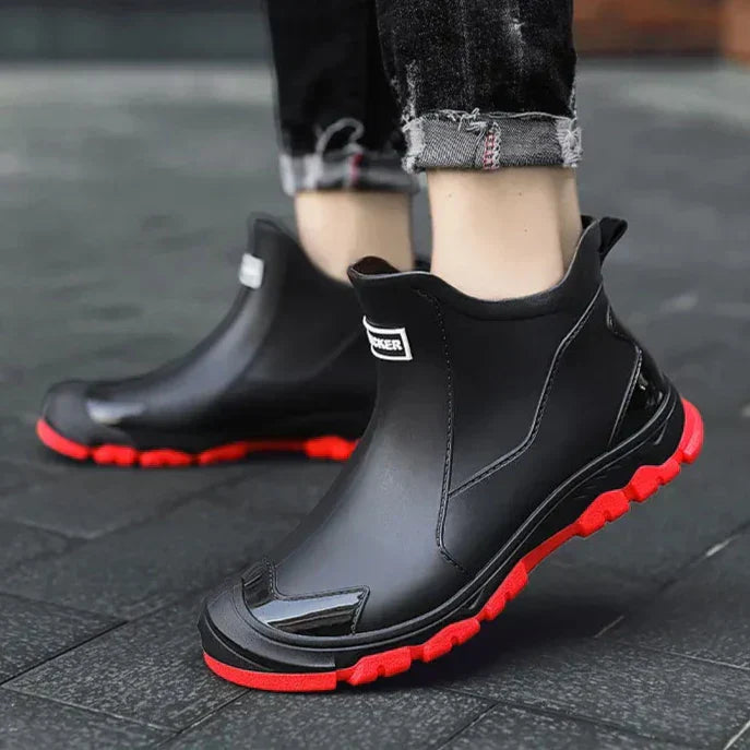 Black unisex ankle terrain boots with elastic side panels and chunky lug soles
