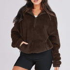 Women's textured hooded half-zip sweater with long sleeves and front pocket