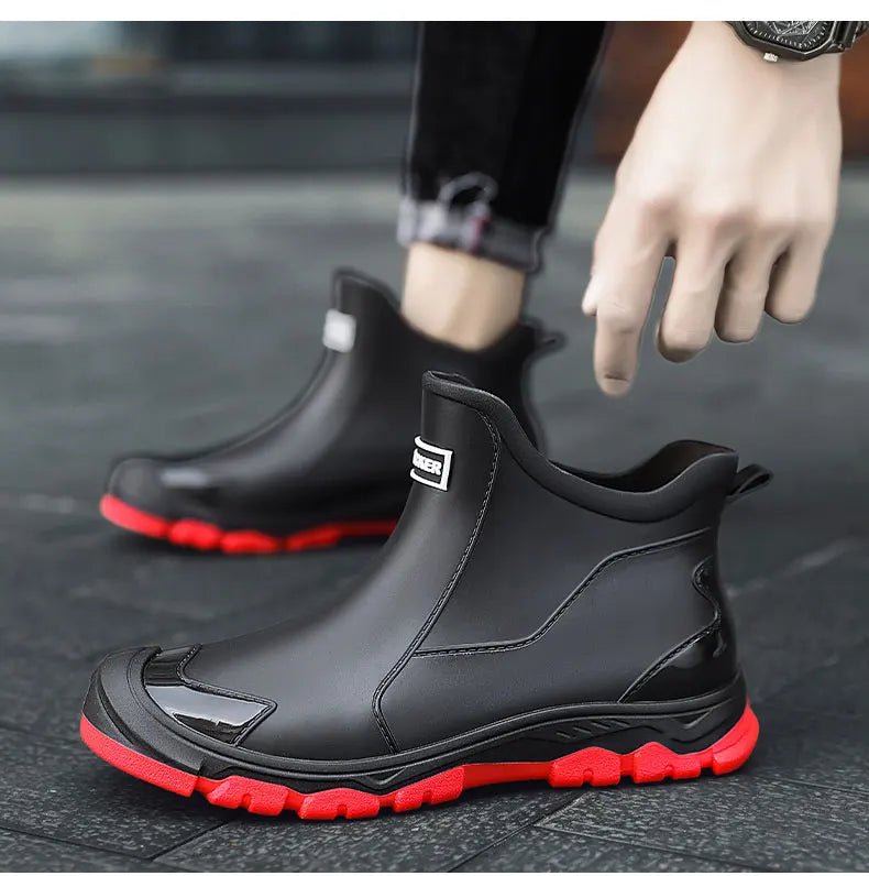 Black unisex ankle terrain boots with elastic side panels and chunky lug soles