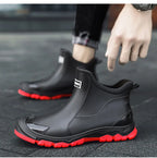 Black unisex ankle terrain boots with elastic side panels and chunky lug soles