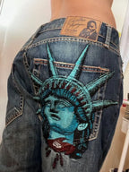 Dark wash wide-leg jeans with a Statue of Liberty back graphic
