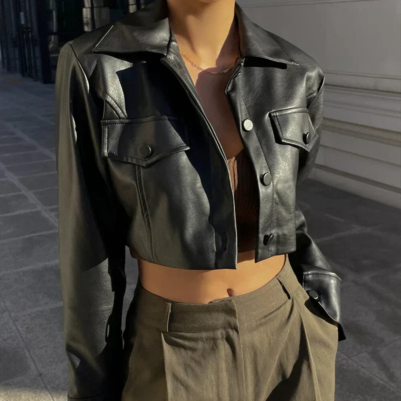 Women's black cropped faux leather jacket with lapel collar and flap pockets