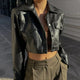 Women's black cropped faux leather jacket with lapel collar and flap pockets