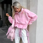 Women's pink textured pullover with stand collar and quarter-zip front