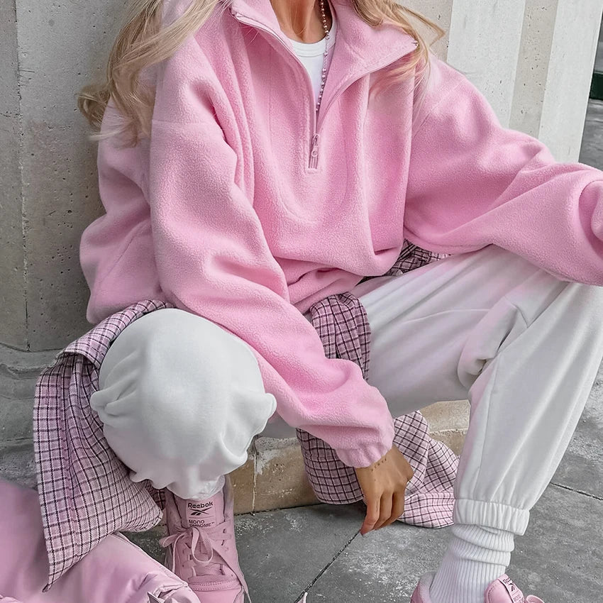 Women's pink textured pullover with stand collar and quarter-zip front