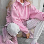 Women's pink textured pullover with stand collar and quarter-zip front