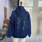 Women's hooded hoodie with large sequin wing motifs on the back