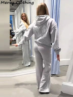 Women's hooded hoodie with large sequin wing motifs on the back
