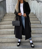 Women's long belted trench coat with notched lapels and double-breasted buttons
